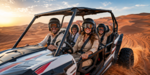 Happy family of four riding in a 4-seater dune buggy through red sand dunes in Lahbab Desert Dubai during golden morning sunrise