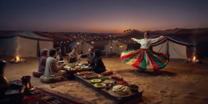 Desert Camp BBQ Dinner and Entertainment – Dubai Safari Experience Traditional Bedouin desert camp with BBQ dinner buffet, live tanoura entertainment, and warm lantern lighting during desert safari with quad bike Dubai experience