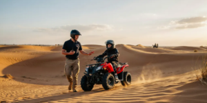 Young rider on a 70cc quad bike exploring the golden Dubai desert with safety helmet and protective gear under instructor supervision