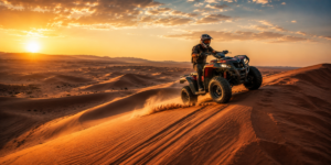 Solo rider on a powerful quad bike conquering the iconic Lahbab Red Dunes in Dubai during golden morning hour with dramatic long shadows