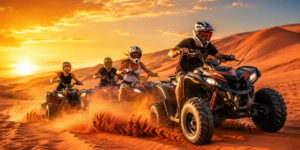 Group of friends riding quad bikes together across the red sand dunes of the Lahbab Desert in Dubai during golden sunset hour