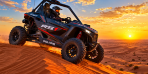 Polaris RS1 single seater dune buggy with 1000cc engine and roll cage parked on red dunes in Dubai during golden hour